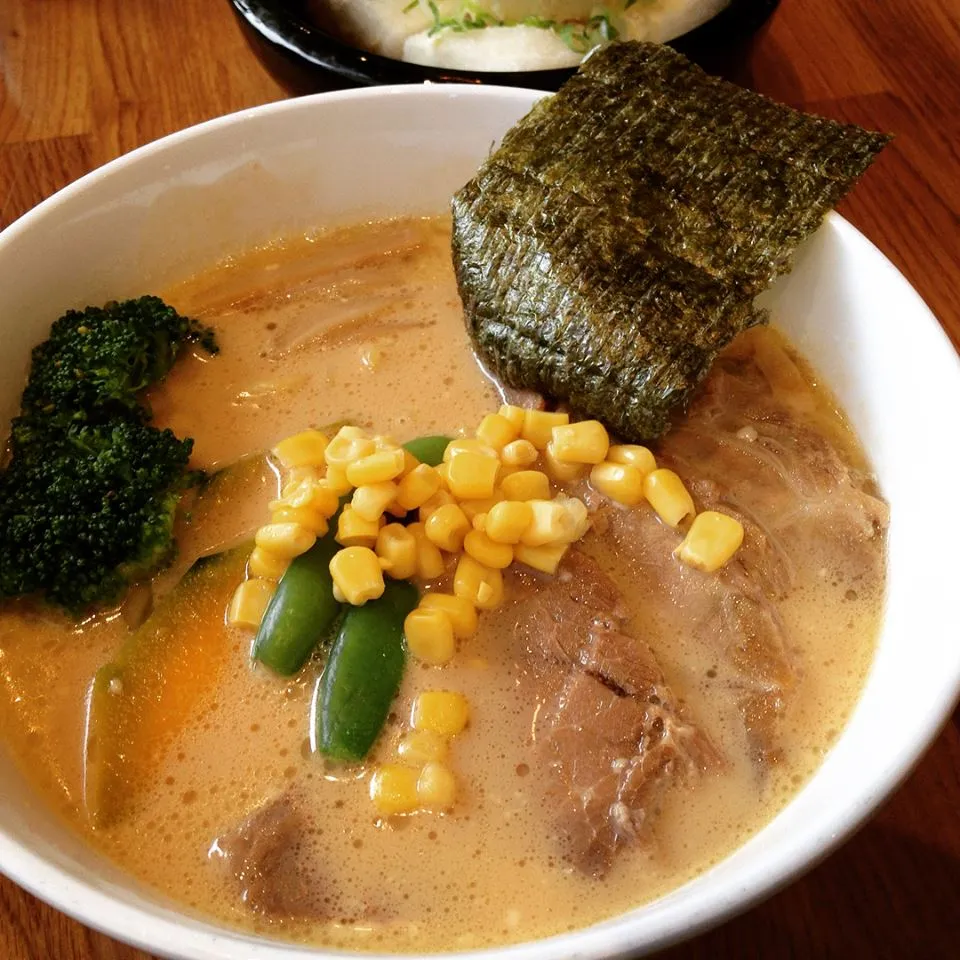 Bowl of ramen with broccoli, corn, nori, and meat
